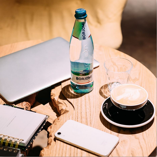 Butelka wody mineralnej mineralnej borjomi na stoliku
